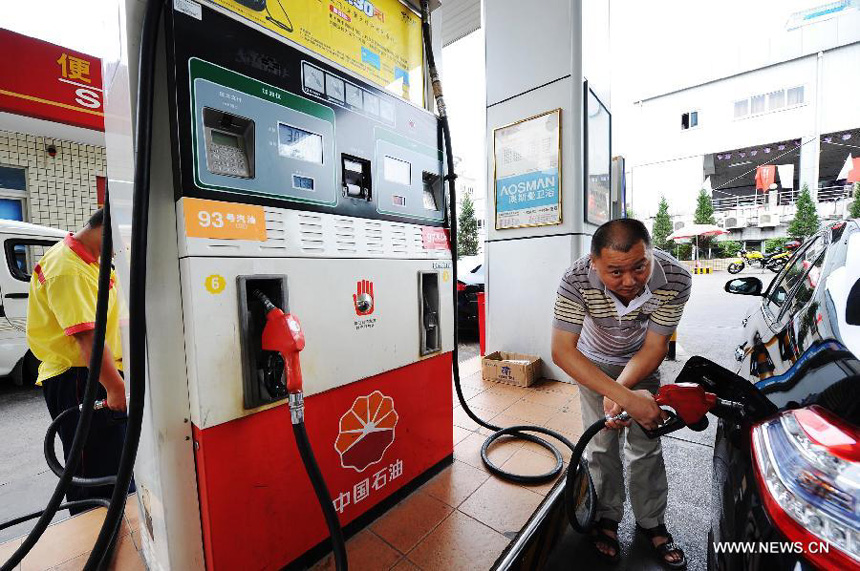 A driver has his vehicle filled with gasoline at a petrol station in Chongqing Municipality, southwest China, Sept. 10, 2012. China will raise the retail prices of gasoline by 550 yuan (85.75 U.S. dollars) per tonne and diesel by 540 yuan per tonne starting Tuesday. The benchmark retail price of gasoline will be lifted by 0.41 yuan per liter and diesel by 0.46 yuan per liter.