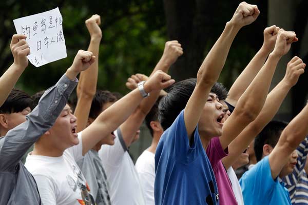 The sentiment of protesters outside the Japanese embassy in Beijing on Tuesday is aptly summed up by the message on a piece of paper: 'The Diaoyu Islands belong to China, Japanese get out.' [Photo/Agencies]