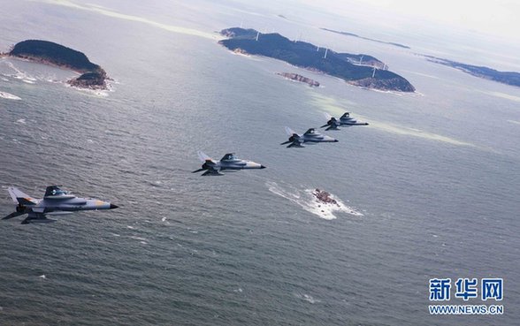 Four fighters fly to the 'war zone' at super low space during a military exercise in the Jinan Military Region.