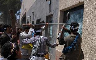 Yemeni protesters break windows of the U.S. embassy in Sanaa, capital of Yemen, on Sept. 13, 2012. At least one protester was killed in clashes when Yemeni security forces tried to disperses hundreds of angry demonstrators who gathered around and inside the U.S. embassy in Sanaa on Thursday as part of widespread anger across the Muslim world over a film ridiculing Islam's Prophet Mohammad, witnesses said. [Mohammed Mohammed/Xinhua]