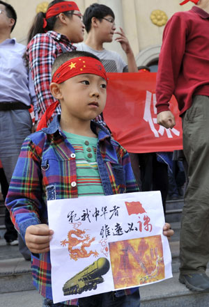  A boy takes part in a protest in Taiyuan, the capital of Shanxi province, on Sept 15. He was one of thousands of protesters across China who voiced their displeasure over Japan's claims on the Diaoyu Islands. [Photo / China News Service]