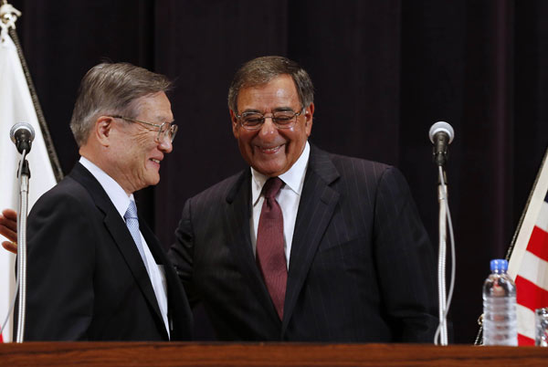 US Secretary of Defense Leon Panetta (right) and Japan's Minister of Defense Satoshi Morimoto smile at the end of a joint news conference at the Ministry of Defense in Tokyo, on Monday. Panetta is on the first official stop of a three-nation tour to Japan, China and New Zealand. [Agencies via China Daily]