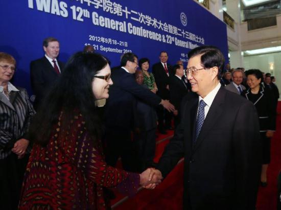 Chinese President Hu Jintao (R, front) shakes hands with an attendee before the opening ceremony of the 12th General Conference and 23rd General Meeting of the Academy of Science for the Developing World (TWAS) in Tianjin, north China, Sept. 18, 2012. [Xinhua]