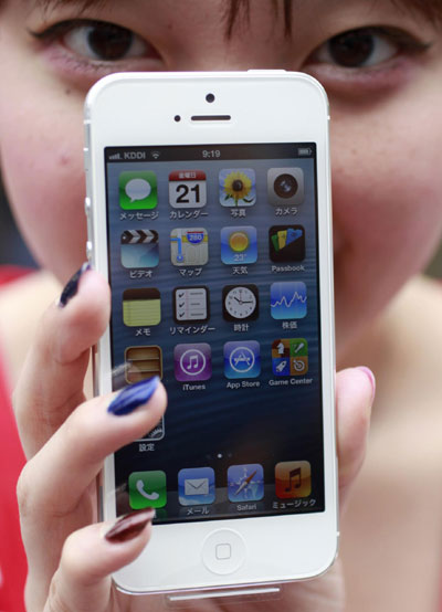 Kae Shibata, 20, shows off her new Apple Inc's iPhone 5 after waiting for two days outside an Apple Store in Tokyo's Ginza district Sept 21, 2012. Apple Inc's iPhone 5 hit stores around the globe on Friday, with fans snapping up the device that is expected to fuel a huge holiday quarter for the consumer giant. [Photo/Agencies] 