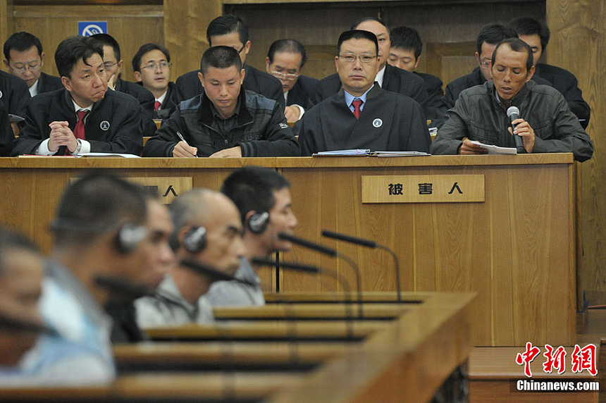 Naw Kham and five other suspects, charged with the murders of 13 Chinese sailors, appear in court in Kunming, Yunnan Province, on Thursday. 