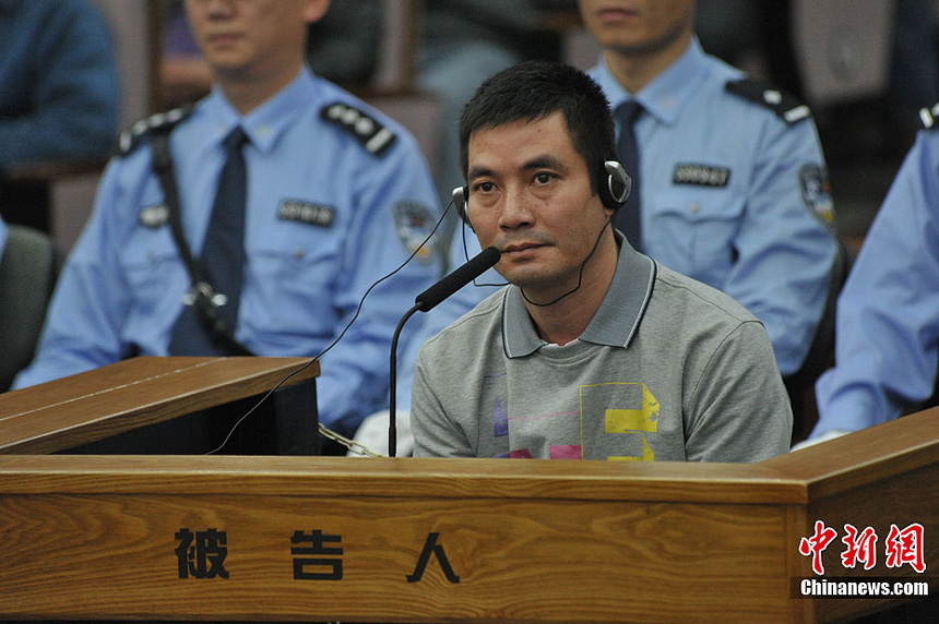 Naw Kham and five other suspects, charged with the murders of 13 Chinese sailors, appear in court in Kunming, Yunnan Province, on Thursday. 