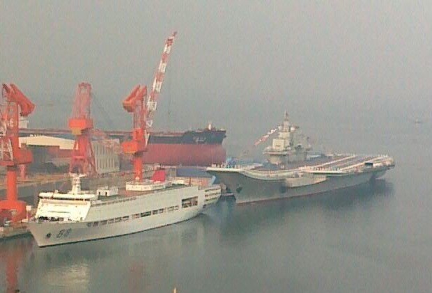 China's first aircraft carrier held a flag-raising ceremony yesterday, amid rising tensions over the Diaoyu Islands in the East China Sea.