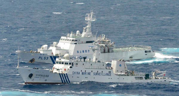 Marine surveillance ship Haijian 66 (front) patrols next to a Japan Coast Guard vessel on Monday near China’s Diaoyu Islands. [Reuters]