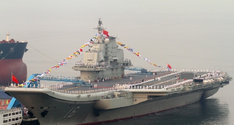 China's first aircraft carrier held a flag-raising ceremony yesterday, amid rising tensions over the Diaoyu Islands in the East China Sea.