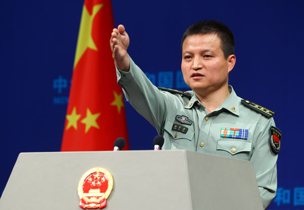 China’s Defense Ministry spokesman Yang Yujun answers questions at a regular news conference in Beijing on Thursday. He dismissed media reports saying that China is building a second aircraft carrier in Shanghai and that it will be unveiled by the end of the year. [Photo/China Daily]