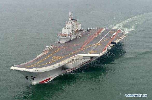 Photo taken in May 2012 shows a Chinese aircraft carrier cruising for a test on the sea. China's first aircraft carrier was delivered and commissioned to the Navy of the Chinese People's Liberation Army on Sept. 25, 2012. The carrier, with the name 'Liaoning' and hull number 16, was officially handed over to the Navy at a ceremony held in a naval base of northeast China's Dalian Port. [Li Tang/Xinhua]