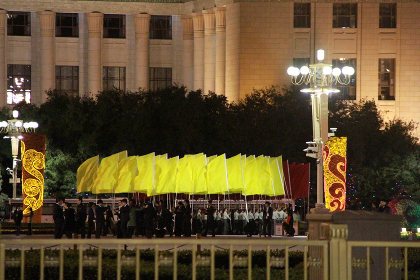 In this photo taken on Sept. 28, 2012, people attend a rehearsal on the Tiananmen Square in Beijing for the celebration of the National Day.