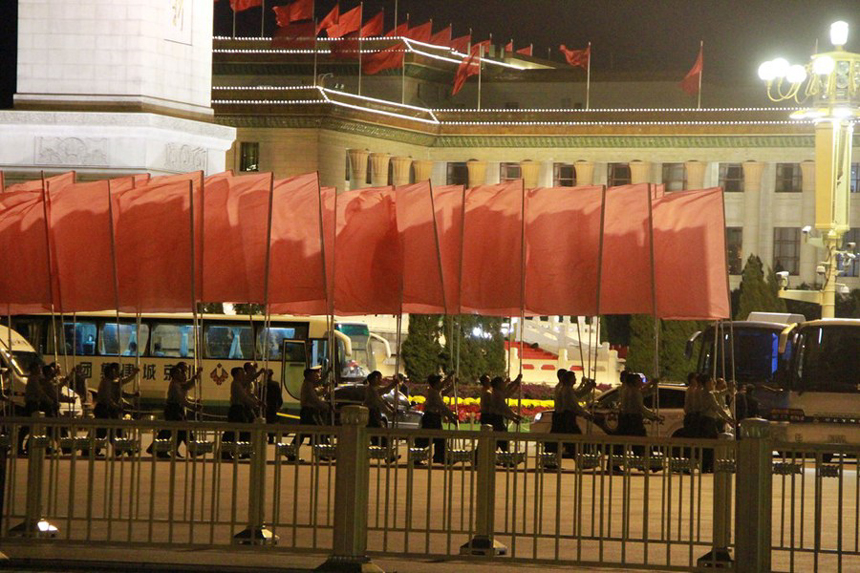 In this photo taken on Sept. 28, 2012, people attend a rehearsal on the Tiananmen Square in Beijing for the celebration of the National Day.