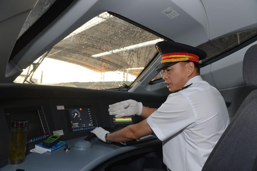 The driver of G538 prepares for the high-speed train&apos;s first trip to Guangzhou in Zhengzhou, capital of central China&apos;s Henan Province, Sept. 29, 2012. Two high-speed train services were put into use Saturday in Zhengzhou, after the Zhengzhou-Wuhan high-speed railway opened on Friday. The new train services, G538 and G650, will reduce travel time to Guangzhou and Wuhan to six hours and two hours respectively. 