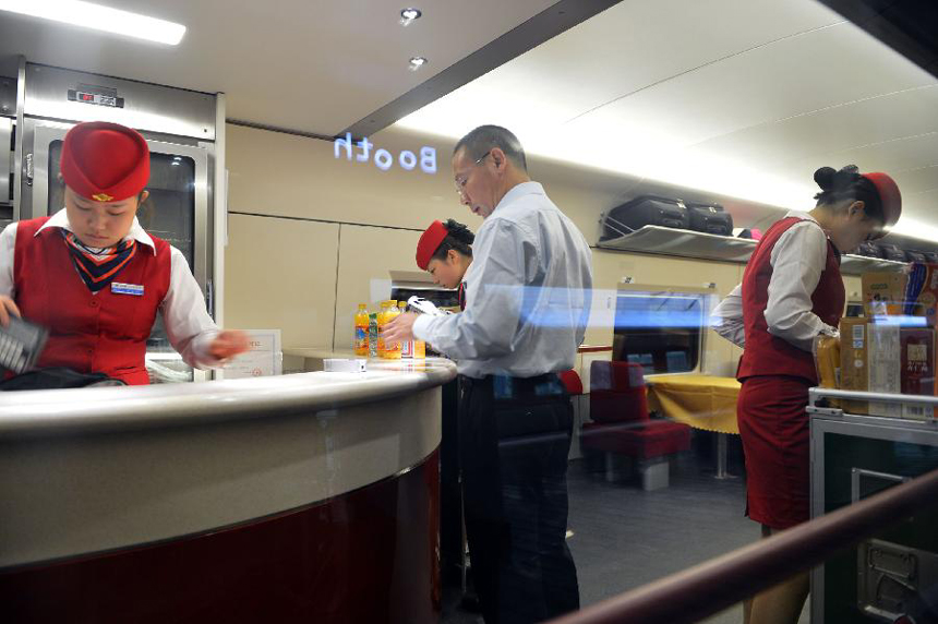 A passenger visits the dining car of high-speed train G538 which travels from central China&apos;s Zhengzhou to Guangzhou in the south, Sept. 29, 2012. Two high-speed train services were put into use Saturday in Zhengzhou, after the Zhengzhou-Wuhan high-speed railway opened on Friday. The new train services, G538 and G650, will reduce travel time to Guangzhou and Wuhan to six hours and two hours respectively. 