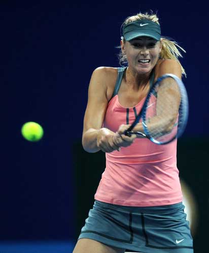 Maria Sharapova of Russia hits a return to Simona Halep of Romania during the women's first round singles match at the China Open tennis tournament in Beijing, capital of China. Sharapova won 2-0. [Xinhua]