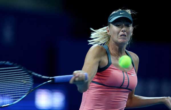 Maria Sharapova of Russia hits a return to Simona Halep of Romania during the women's first round singles match at the China Open tennis tournament in Beijing, capital of China. Sharapova won 2-0. [Xinhua]