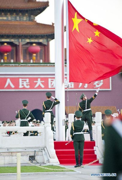 Chinese national flag is raised at the Tian'anmen Square in Beijing, capital of China, Oct. 1, 2012. Tens of thousands of people gathered at the Tian'anmen Square to watch the national flag raising ceremony at dawn on Oct. 1, in celebration of the 63rd anniversary of the founding of the People's Republic of China. [Photo: Xinhua/Cao Can]