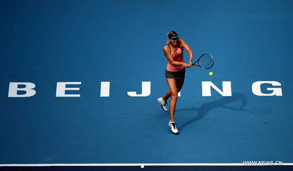 Maria Sharapova of Russia returns the ball during the women's singles 3rd round match against Polona Hercog of Slovenia at the China Open tennis tournament in Beijing, China, on Oct. 4, 2012. Sharapova won 2-0. [Xinhua]