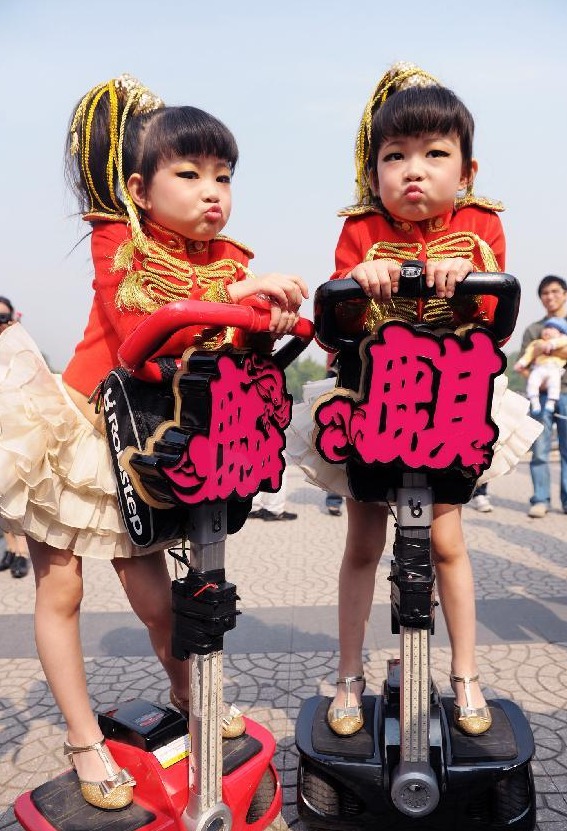 A pair of twin sisters are seen at the 9th Beijing Twin Festival in Beijing, capital of China, Oct. 2, 2012. 