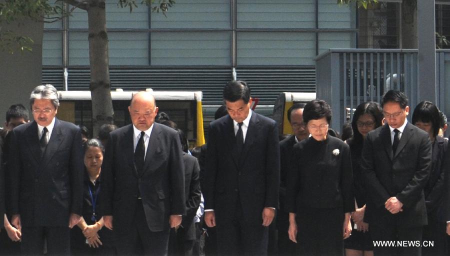 Hong Kong Chief Executive CY Leung (C) and other principal officials observe three minutes of silence in mourning to pay last respects to the victims of a fatal ferry crash in front of the city government's headquarters in Hong Kong on Oct. 4, 2012. Thirty-eight people including at least five children were killed after two ferries collided on Monday evening off Hong Kong' s Lamma Island.