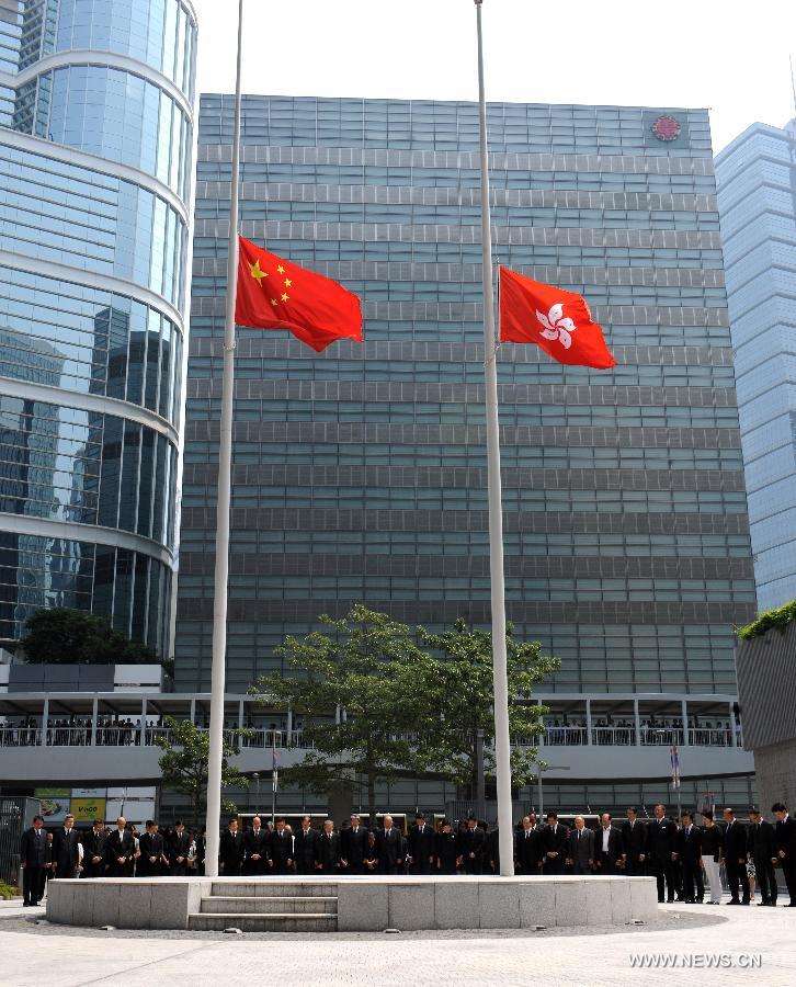 Hong Kong Chief Executive CY Leung and other principal officials observe three minutes of silence in mourning to pay last respects to the victims of a fatal ferry crash in front of the city government's headquarters in Hong Kong on Oct. 4, 2012. Thirty-eight people including at least five children were killed after two ferries collided on Monday evening off Hong Kong' s Lamma Island. 