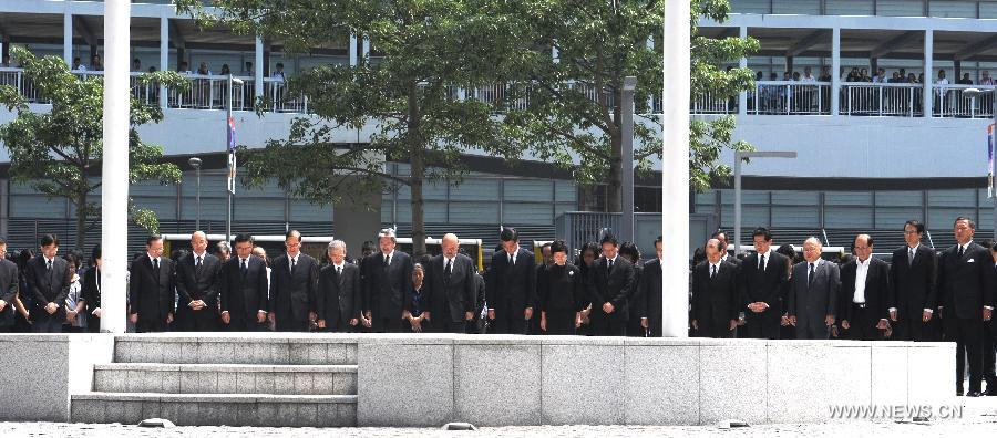 Hong Kong Chief Executive CY Leung and other principal officials observe three minutes of silence in mourning to pay last respects to the victims of a fatal ferry crash in front of the city government's headquarters in Hong Kong on Oct. 4, 2012. Thirty-eight people including at least five children were killed after two ferries collided on Monday evening off Hong Kong' s Lamma Island. 