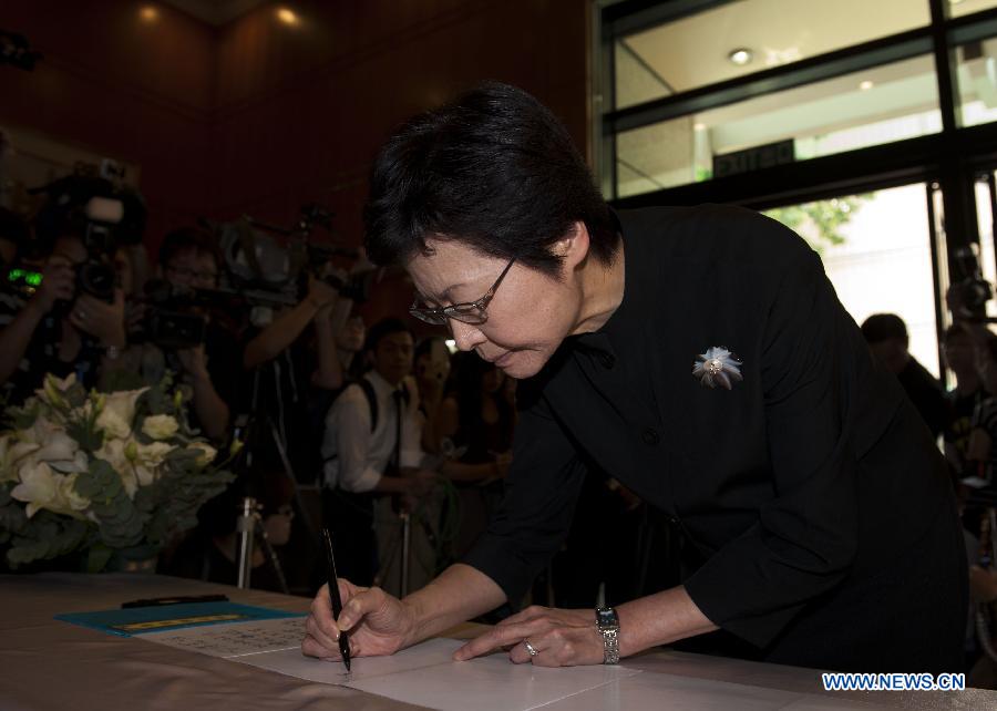 Carrie Lam Cheng Yuet-ngor, Chief Secretary for Administration of Hong Kong, signs at a condolence place in Wanchai of Hong Kong on Oct. 4, 2012. Eighteen condolence places were set up in Hong Kong Thursday to mourn for the victims of the ferry accident during which thirty-eight people including at least five children were killed. 