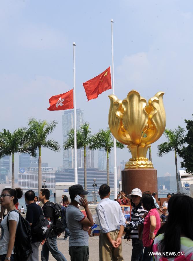 The Chinese and Hong Kong Special Administrative Region flags fly at half mast at the Golden Bauhinia Square in Hong Kong on Oct. 4, 2012. Flags flew at half mast around Hong Kong as the territory started three days of mourning to pay last respects to the victims of a fatal ferry crash.