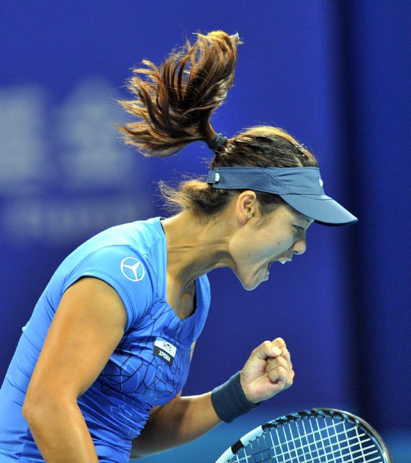 Li Na of China reacts during the women's singles 3rd round match against Peng Shuai of China at the China Open tennis tournament in Beijing China, on Oct. 4, 2012. 