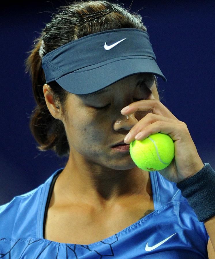 Li Na of China gestures during the women's singles 3rd round match against Peng Shuai of China at the China Open tennis tournament in Beijing China, on Oct. 4, 2012. 