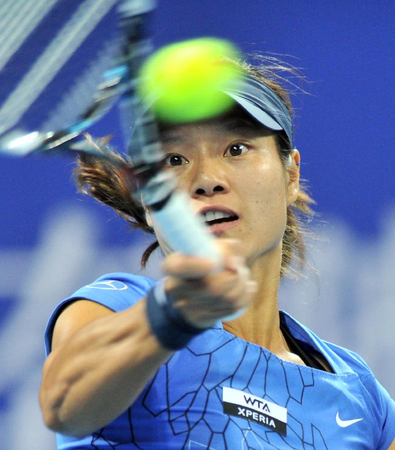 Li Na of China returns the ball during the women's singles 3rd round match against Peng Shuai of China at the China Open tennis tournament in Beijing China, on Oct. 4, 2012. 