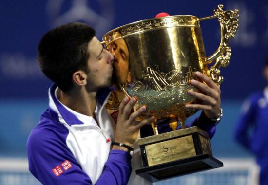 Novak Djokovic of Serbia holds the trophy during the victory ceremony for the men's singles final against Jo-Wilfried Tsonga of France at the 2012 China Open tennis tournament held in Beijing, capital of China, on Oct. 7, 2012. Djokovic won the match 2-0 and claimed the title.