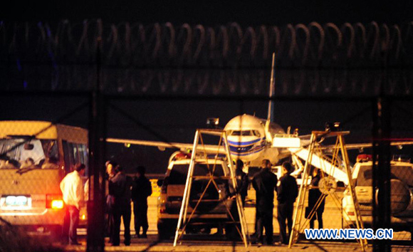 Officials with the local public security department handle a passenger plane forced landing incident at Gansu Zhongchuan Airport in Lanzhou, Gansu Province, Oct. 8, 2012. 