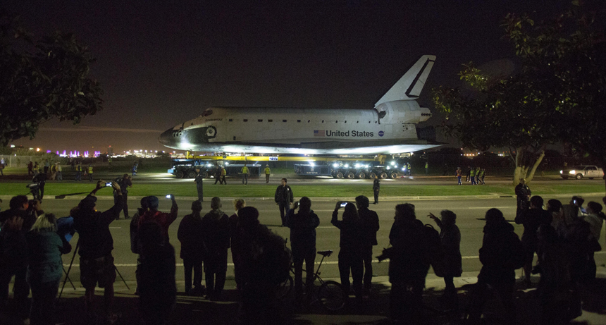 People take pictures as the Space Shuttle Endeavour leaves Los Angeles International Airport in Los Angeles, California, in the early morning hours October 12, 2012 . Endeavour on Friday and begins a two-day ground journey to its final resting place at the California Science Center. NASA Space Shuttle Program ended in 2011 after 30 years and 135 missions. [Xinhua photo]