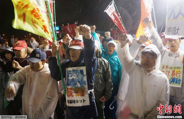 Japanese hold placards to protest the alleged rape of a local woman by two US servicemen in Okinawa, in front of the prime minister's official residence in Tokyo on Wednesday. 