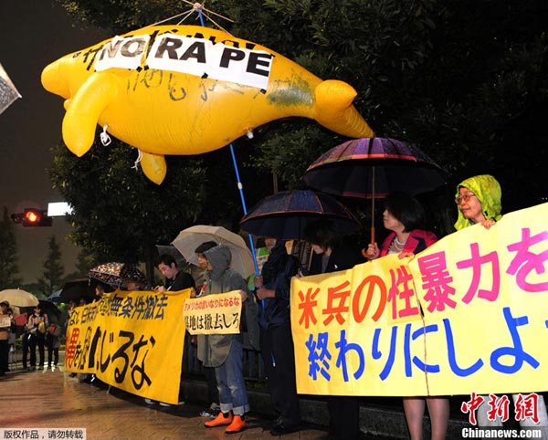 Japanese hold placards to protest the alleged rape of a local woman by two US servicemen in Okinawa, in front of the prime minister's official residence in Tokyo on Wednesday. 