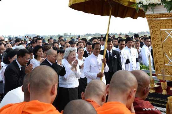 Cambodian Queen-Mother Norodom Monineath Sihanouk, King Norodom Sihamoni, and Prime Minister Hun Sen are seen next to the coffin of late Cambodian King-Father Norodom Sihanouk after arriving at the airport of Phnom Penh, Cambodia, Oct. 17, 2012.
