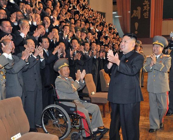 North Korea's top leader Kim Jong Un has a photo session with the participants in the meeting for celebrating the 65th anniversary of Mangyongdae Revolutionary School and Kang Pan Sok Revolutionary School, according to the country's official news agency KCNA's report on Oct. 16, 2012. [Xinhua]