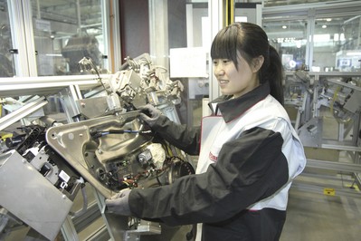 Worker working at the production line of Brose Beijing plant. 