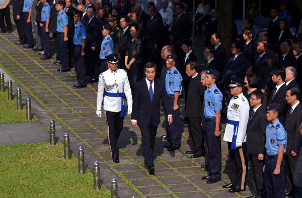 Hong Kong Chief Executive C Y Leung (L, front) attends an official ceremony in commemoration of those who died in defending Hong Kong during the second World War in Hong Kong, south China, Oct. 23, 2012.