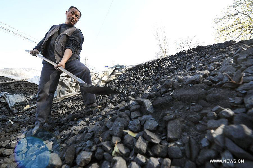 A villager collects coals at a coal yard in Xinmin Township of Jingyuan County, northwest China&apos;s Ningxia Hui Autonomous Region, on Oct. 31, 2012. As temperatures drop drastically in Ningxia, residents in its rural areas begin storing coals for heating in winter. Burning coals in winter is the most common way to keep out the cold in north China&apos;s rural areas lack of heating systems.