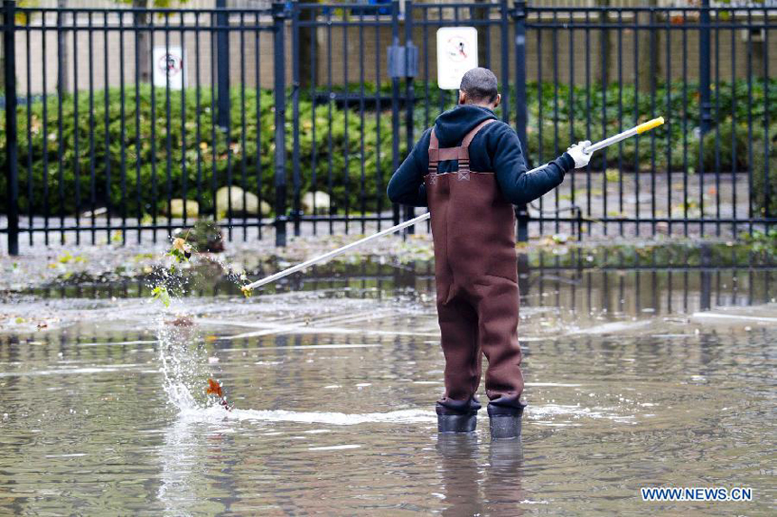 A worker cleans out gutters in Hoboken of New Jersey, the United States, on Oct. 31, 2012. Hurricane Sandy lashed the U.S. east coast and made a landfall in New Jersey Monday evening, knocking out power for millions and killing at least 64 people. 