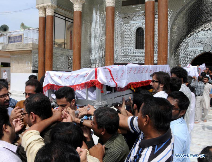 People carry coffins during a funeral ceremony of violence victims in southern Pakistani port city of Karachi on Oct. 31, 2012. At least nine people including a police constable were killed in Karachi in different firing incidents during last 12 hours.