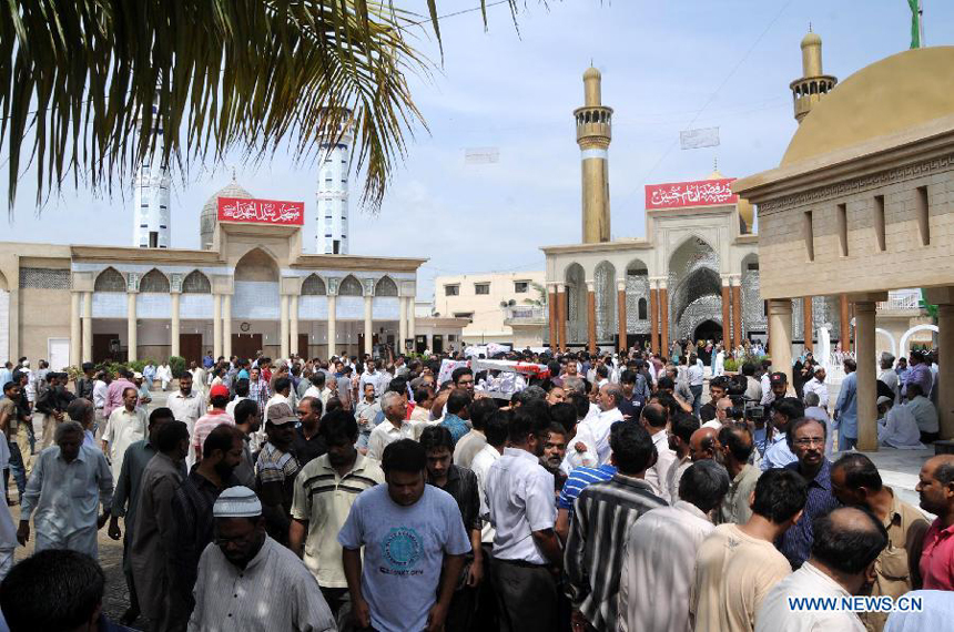 People attend a funeral ceremony of violence victims in southern Pakistani port city of Karachi on Oct. 31, 2012. At least nine people including a police constable were killed in Karachi in different firing incidents during last 12 hours. 