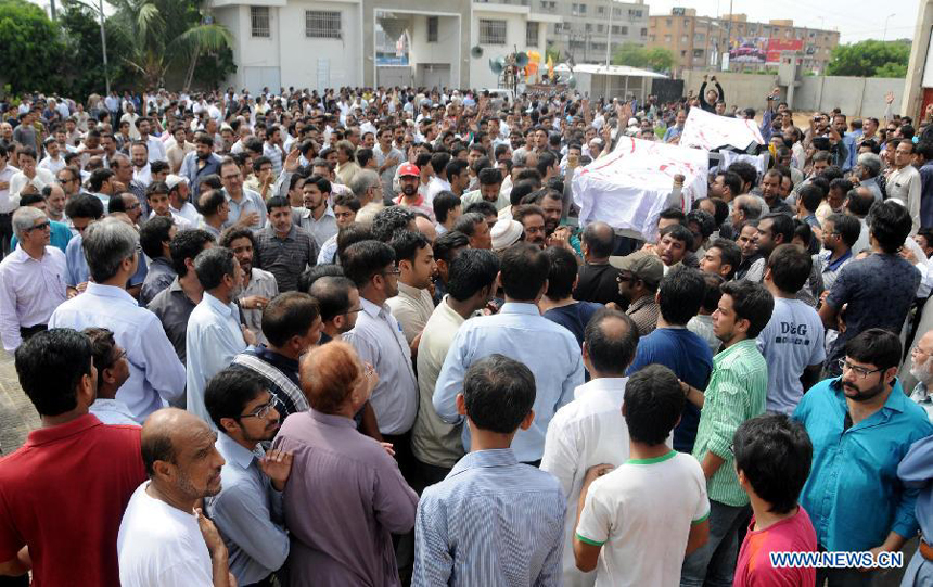 People carry coffins during a funeral ceremony of violence victims in southern Pakistani port city of Karachi on Oct. 31, 2012. At least nine people including a police constable were killed in Karachi in different firing incidents during last 12 hours.