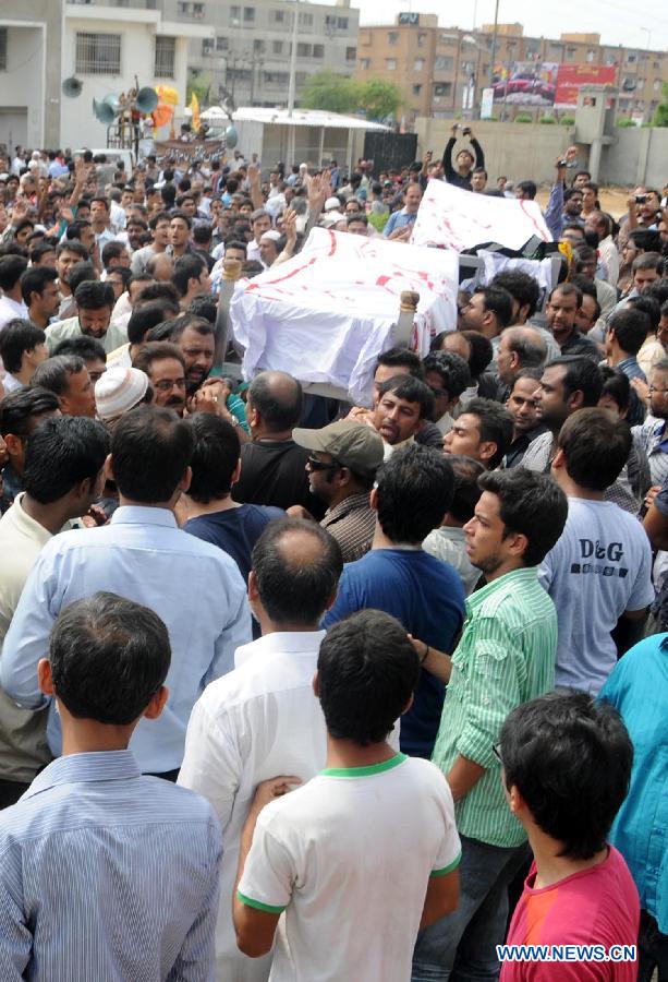 People carry coffins during a funeral ceremony of violence victims in southern Pakistani port city of Karachi on Oct. 31, 2012. At least nine people including a police constable were killed in Karachi in different firing incidents during last 12 hours. 