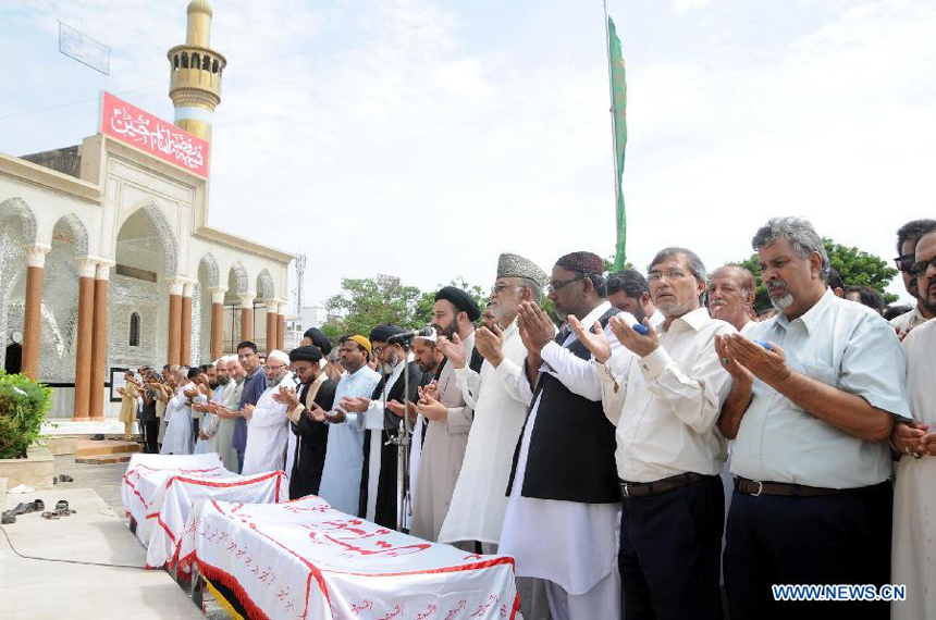 People attend a funeral ceremony of violence victims in southern Pakistani port city of Karachi on Oct. 31, 2012. At least nine people including a police constable were killed in Karachi in different firing incidents during last 12 hours.