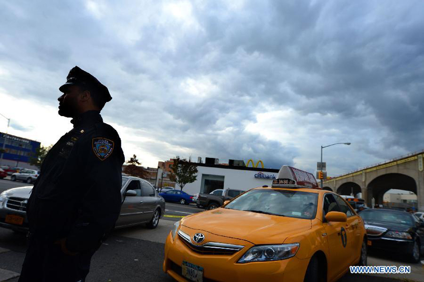 A policeman patrols near a gas station in Queens, New York, the United States, Nov. 2, 2012. Four days after superstorm Sandy smashed into the U.S. Northeast, security measures were tightened up in New York as anger mounted over gasoline shortages, power outages and waits for relief supplies.