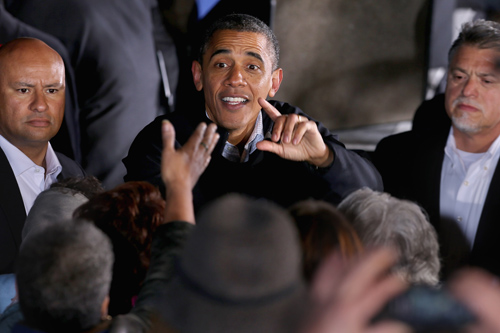 U.S. President Barack Obama greets supporters during a campaign rally at Washington Park November 3, 2012 in Dubuque, Iowa. Obama and Republican foe Mitt Romney power into a final weekend of campaigning before handing their fates to voters after a bitter, gruelling White House race, which will take place on November 6.[Xinhua/AFP]